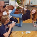 Goat Yoga Party Game - Woman balancing an inflatable goat on her body